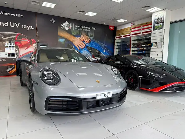 Porsche 911 and Lamborghini in Showroom